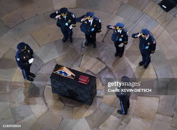 Mourners pay their respects during a ceremony for US Capitol Police officer Brian Sicknick as he lays in honor in the Rotunda of the US Capitol...