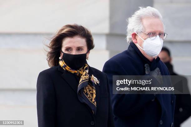 Speaker of the House Nancy Pelosi and Senate Minority Leader Mitch McConnell watch a police motorcade follow a hearse carrying the remains of Capitol...