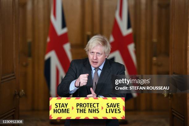 Britain's Prime Minister Boris Johnson attends a virtual press conference inside 10 Downing Street in central London on February 3 to give an update...