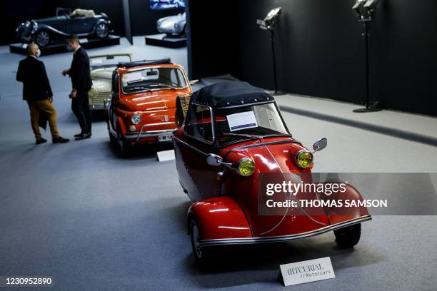 This picture taken on February 3, 2021 shows shows a 1957 Messerschmitt KR200 and a 1971 Fiat 500 displayed at the Artcurial auction house in Paris...