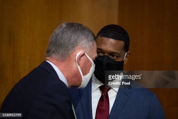 Nominee for Administrator of the Environmental Protection Agency Michael Regan talks with Sen. Richard Burr prior to his confirmation hearing before...