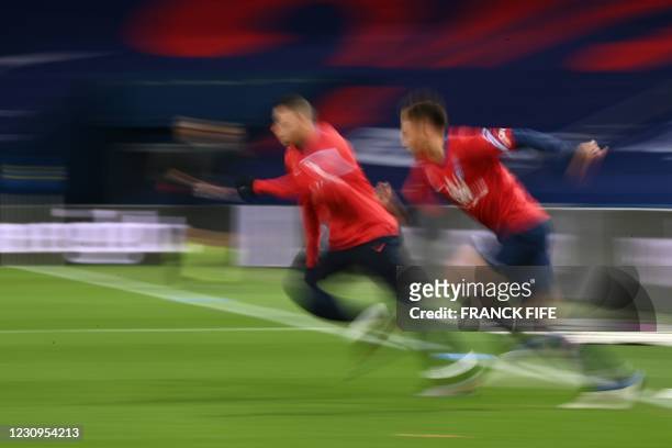 Paris Saint-Germain's French forward Kylian Mbappe and Paris Saint-Germain's German defender Thilo Kehrer warm up prior to the French L1 football...