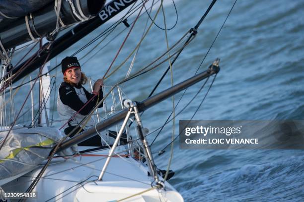 French skipper Clarisse Cremer reacts aboard her Imoca 60 monohull "Banque Populaire X" after crossing the finish line of the Vendee Globe...