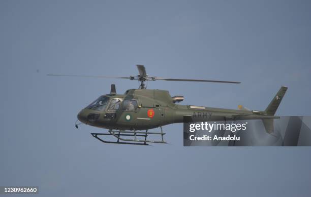 Pakistani army helicopter hovers over Pindi Cricket Stadium as part of security measures during the first day play of 2nd cricket Test match between...