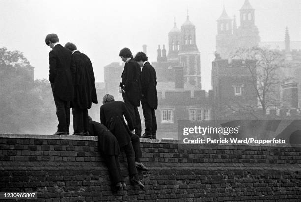 Eton College students looking down on the annual Eton Wall Game, a unique college tradition, Berkshire, England, 1st November 1976. This image is...