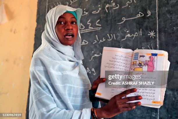 Picture taken in the South Darfur village of Hamada, north of the region's capital town Nyala on February 3 shows a teacher at a school as residents...