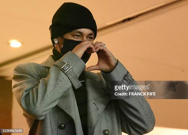 Paris Saint-Germain's Brazilian forward Neymar makes the sign of a heart as he attends the French L1 football match between Paris Saint-Germain and...
