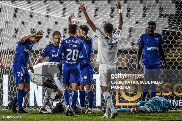 Players react gesturing to Porto's Bissau Guinean defender Nanu's collision with Belenenses' Russian goalkeeper Stanislav Kritsyuk during the...