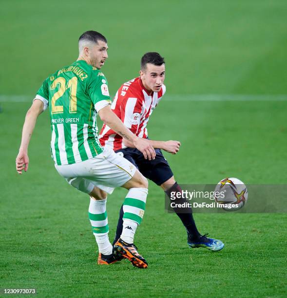 Alejandro Berenguer Remiro of Athletic Club and Guido Rodriguez of Real Betis Balompie battle for the ball during the Copa del Rey match between Real...
