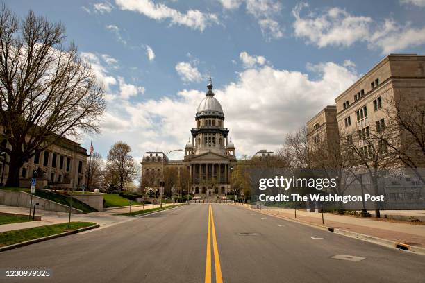 The Illinois State Capitol building stands among empty streets in Springfield, Illinois on April 9, 2020.