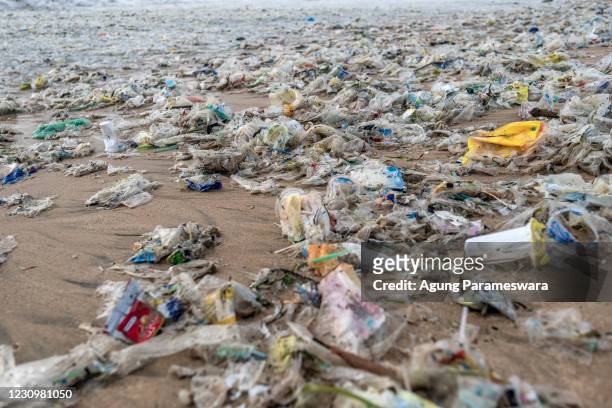 Plastic trash scattered on the beach which was brought in by the strong wave during the northwest monsoon season at Jimbaran beach on January 27,...