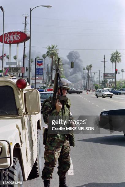 National Guardsman holds his rifle as he patrols the streets of Los Angeles on April 30, 1992. The National Guard was brought in to control rioters...