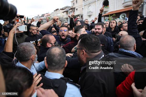 Israeli police take measures as Israeli Arabs march to protest against the raise in crime and violence after performing the Friday prayer outside the...