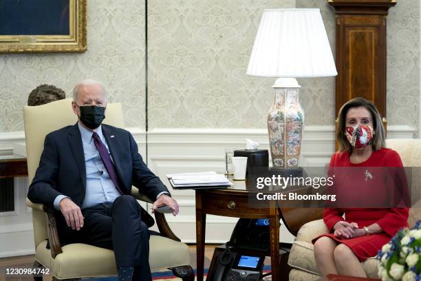 President Joe Biden, left, and U.S. House Speaker Nancy Pelosi, a Democrat from California, wear protective masks during a meeting in the Oval Office...