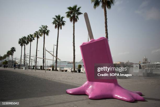 An installation with a sculpture of a melted ice cream is pictured on an empty street at a commercial area in Malaga. Many stores, shops and...