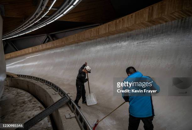 Workers prepare the ice at the National Sliding Center, that was built for the bobsled and luge events to be held at the Beijing 2022 Winter Olympics...