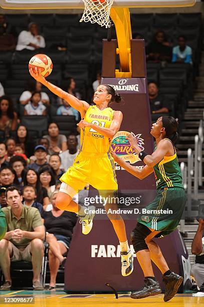 Ticha Penicheiro of the Los Angeles Sparks attempts a reverse layup against the Seattle Storm at Staples Center on August 30, 2011 in Los Angeles,...