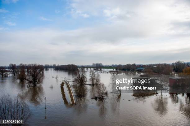 Small bridge seen underwater in the river. Because of the very heavy rains in Germany flood plains along the banks of the Rhine and other major...