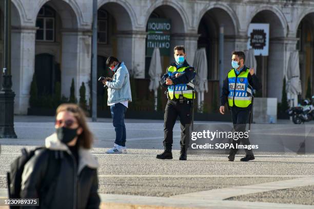 Two Portuguese police officers wearing face mask walk around Praça do Comércio in Lisbon. Portugal has registered 13,740 deaths and 755,774 confirmed...