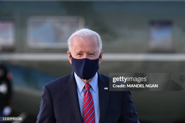 President Joe Biden makes his way to board Air Force One before departing from Andrews Air Force Base in Maryland on February 5, 2021. - Biden is...