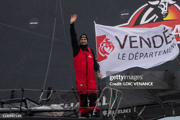 French skipper Jeremie Beyou celebrates on his Imoca 60 monohull "Charal" as he crosses the finish line, placed 13th, of the Vendee Globe...