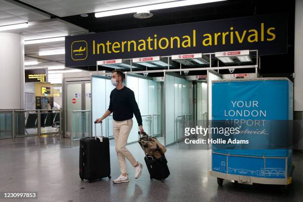 Traveler arrives at the North Terminal at Gatwick Airport on February 6, 2021 in London, England. The UK Government has confirmed that anyone...