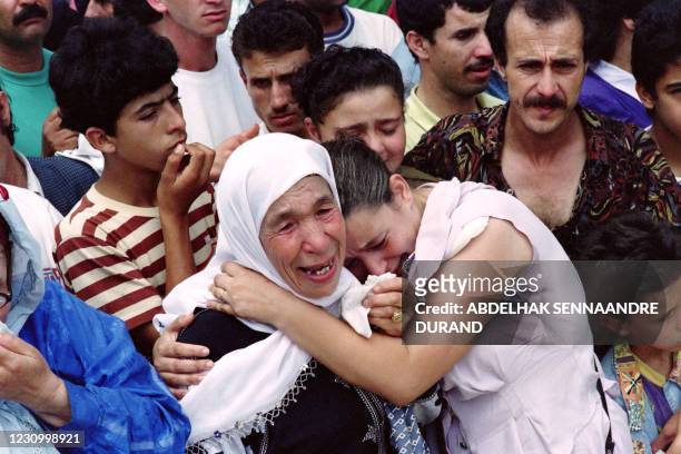 An old woman and a young woman cry together during the funeral of Algerian President Mohamed Boudiaf on July 01, 1992 in Algiers. Boudiaf was shot...