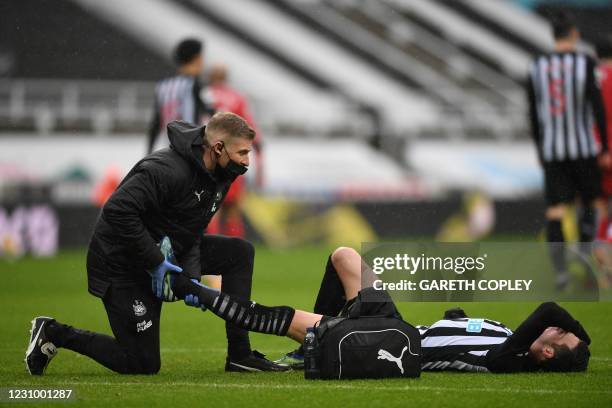 Newcastle United's Argentinian defender Federico Fernandez receives medical treatment during the English Premier League football match between...