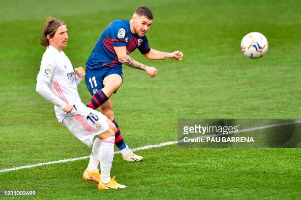 Huesca's Spanish defender Javi Galan scores a goal past Real Madrid's Croatian midfielder Luka Modric during the Spanish league football match...