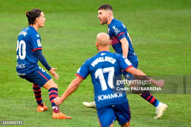 Huesca's Spanish defender Javi Galan celebrates with Huesca's Spanish midfielder Jaime Seoane after scoring a goal during the Spanish league football...