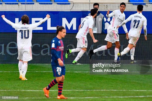 Real Madrid's French defender Raphael Varane celebrates with teammates after scoring a second goal during the Spanish league football match between...