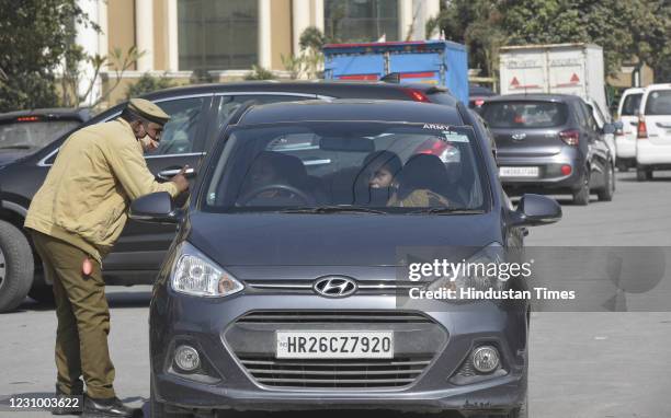 Commuters negotiatiing passage with a traffic police personnel at a roadblock during a nationwide call for Chakka Jam by farmers unions, on February...