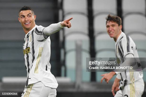 Juventus' Portuguese forward Cristiano Ronaldo celebrates with Juventus' Italian forward Federico Chiesa after opening the scoring during the Italian...