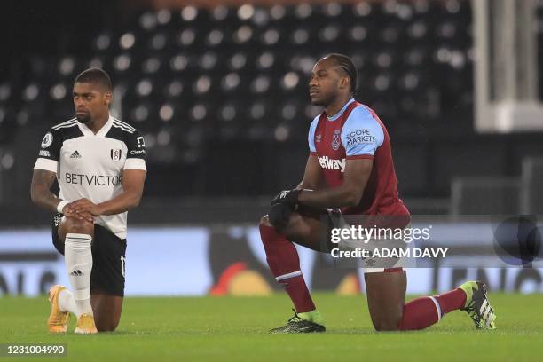 West Ham United's English midfielder Michail Antonio takes a knee against racism during the English Premier League football match between Fulham and...