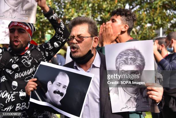 Protester holding Cholri Belaid portraits during a demonstration against government and police repression as they commemorate the 8th anniversary of...