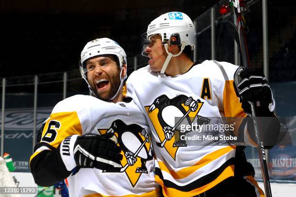 Evgeni Malkin of the Pittsburgh Penguins is congratulated by Jason Zucker after scoring a goal against the New York Islanders during the second...