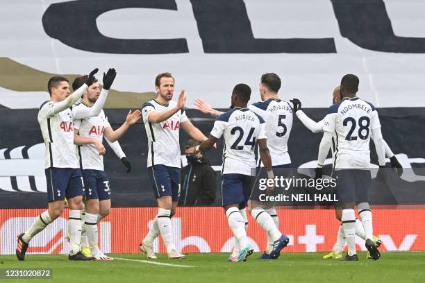 Tottenham Hotspur's English striker Harry Kane celebrates with teammates after scoring the opening goal of the English Premier League football match...