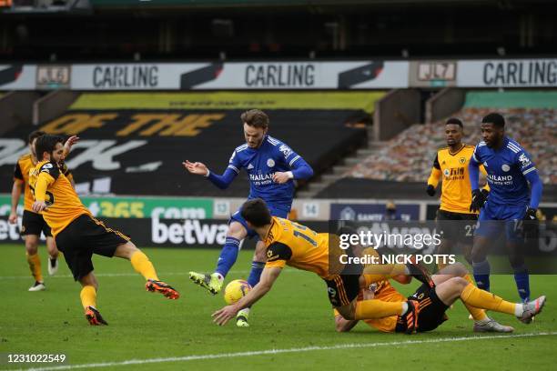 Leicester City's English midfielder James Maddison has this shot blocked in a goal-mouth scramble during the English Premier League football match...