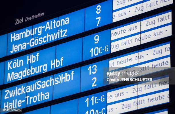 Destination board of the Deutsche Bahn displays cancelled trains at the central station in Halle/Saale, eastern Germany, on January 07, 2021. - With...
