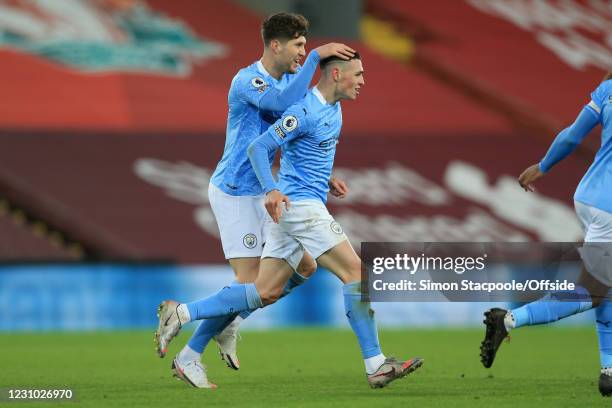 Phil Foden of Man City celebrates scoring their 4th goal with John Stones during the Premier League match between Liverpool and Manchester City at...