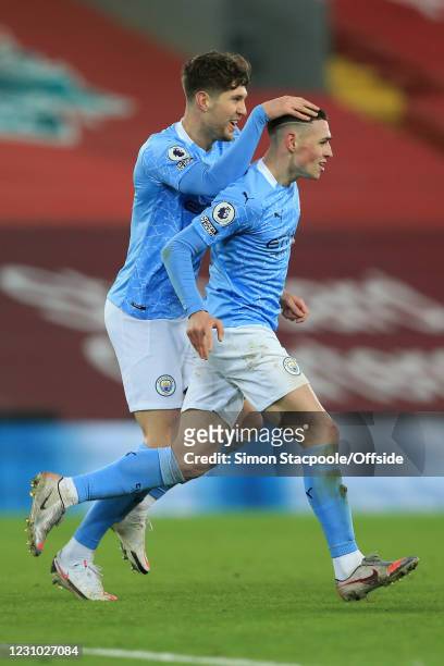 Phil Foden of Man City celebrates scoring their 4th goal with John Stones during the Premier League match between Liverpool and Manchester City at...