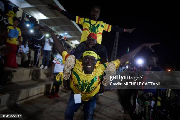 People support the Malian football team during the projection of the final match of the African Nations Championship between Mali and Morocco in the...