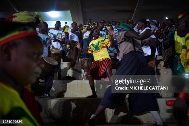 Supporters of the Mali football team watch the projection of the final match of the African Nations Championship between Mali and Morocco in the...