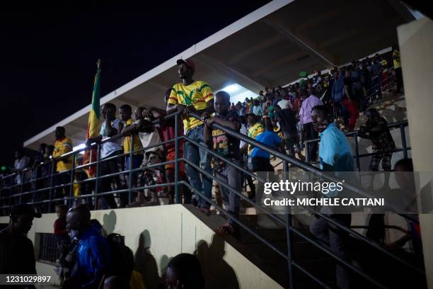 Supporters of the Mali football team watch the projection of the final match of the African Nations Championship between Mali and Morocco in the...