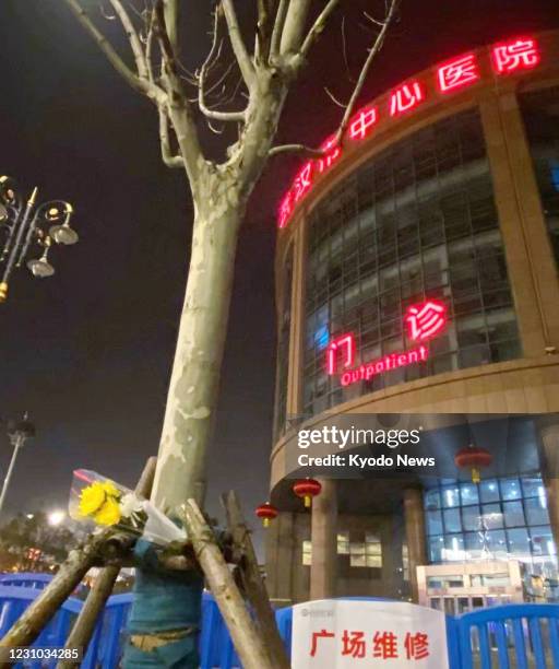 Flowers are seen in front of the Central Hospital of Wuhan in the Chinese city in memory of late doctor Li Wenliang, who was an early whistleblower...