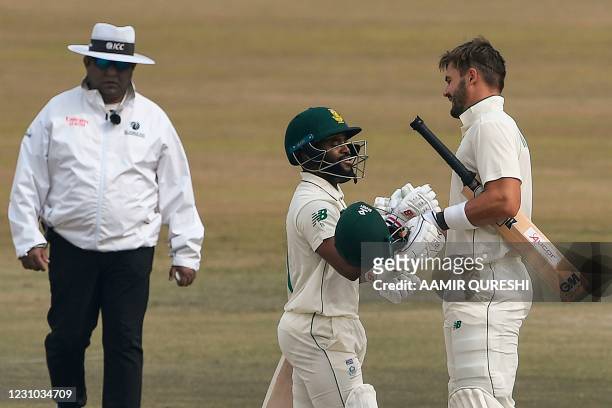 South Africa's Aiden Markram celebrates with teammate Temba Bavuma after scoring a century during the fifth and final day of the second Test cricket...