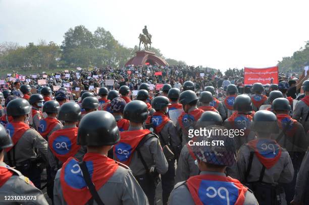 Phalanx of riot police face off protestors during a demonstration against the military coup at the monument of General Aung San , the late father of...