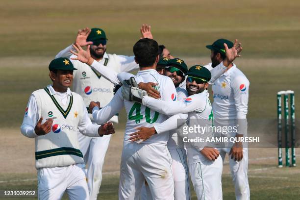 Pakistan's players celebrate after the dismissal of South Africa's Keshav Maharaj during the fifth and final day of the second Test cricket match...