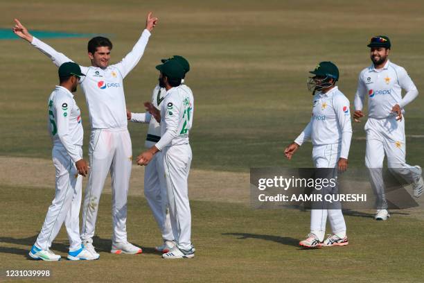 Pakistan's Shaheen Shah Afridi celebrates with teammates after the dismissal of South Africa's Keshav Maharaj during the fifth and final day of the...