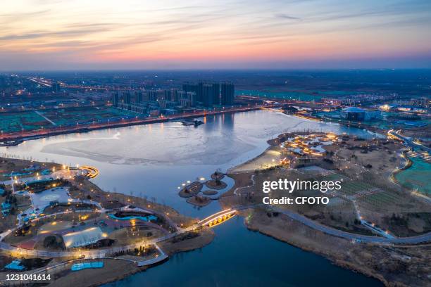 An aerial photo shows the Beihai Park decorated with lights at night in Binzhou, east China's Shandong province, Feb 7, 2021.-